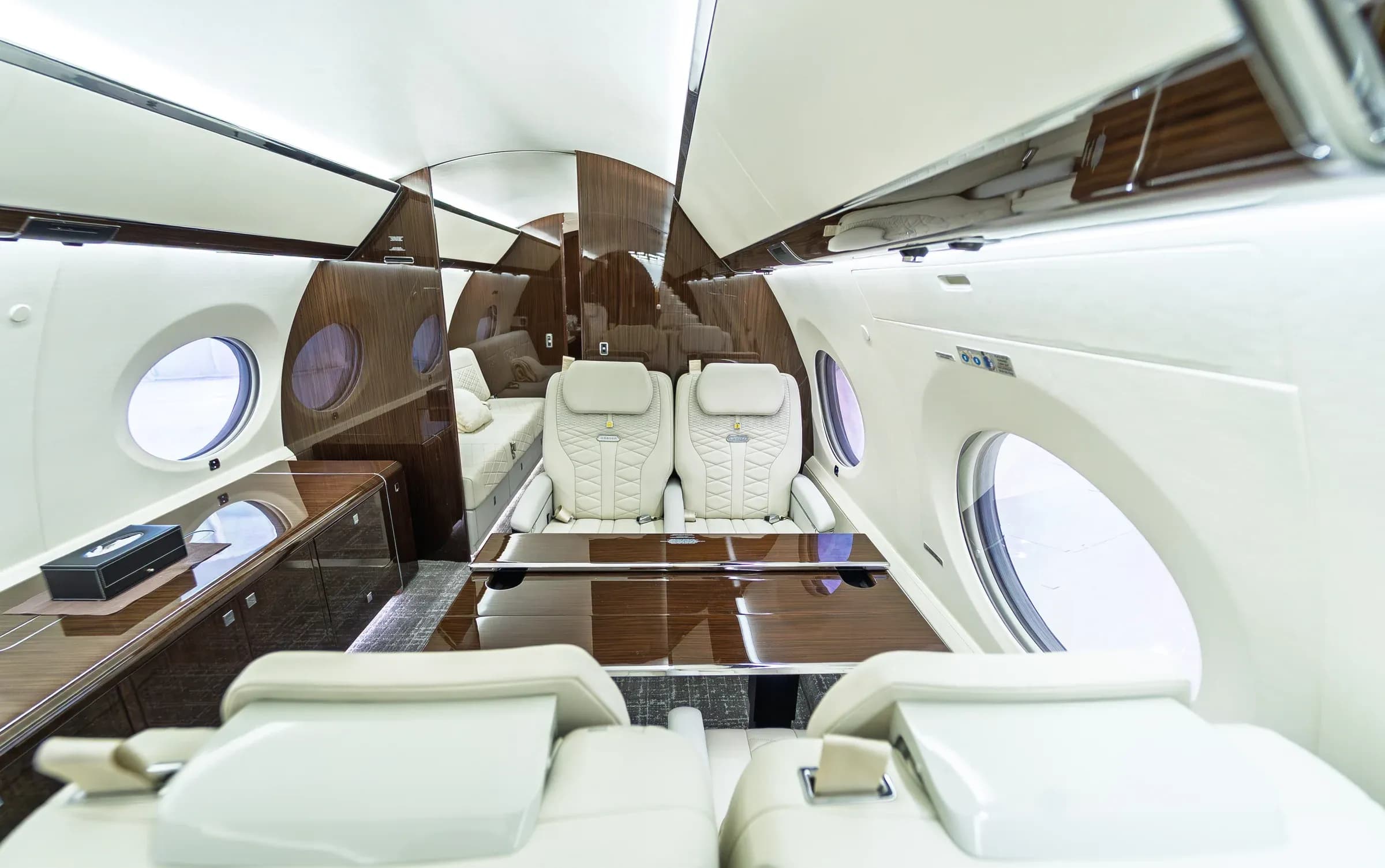 Gulfstream G650ER club seating around a glossy wood table.