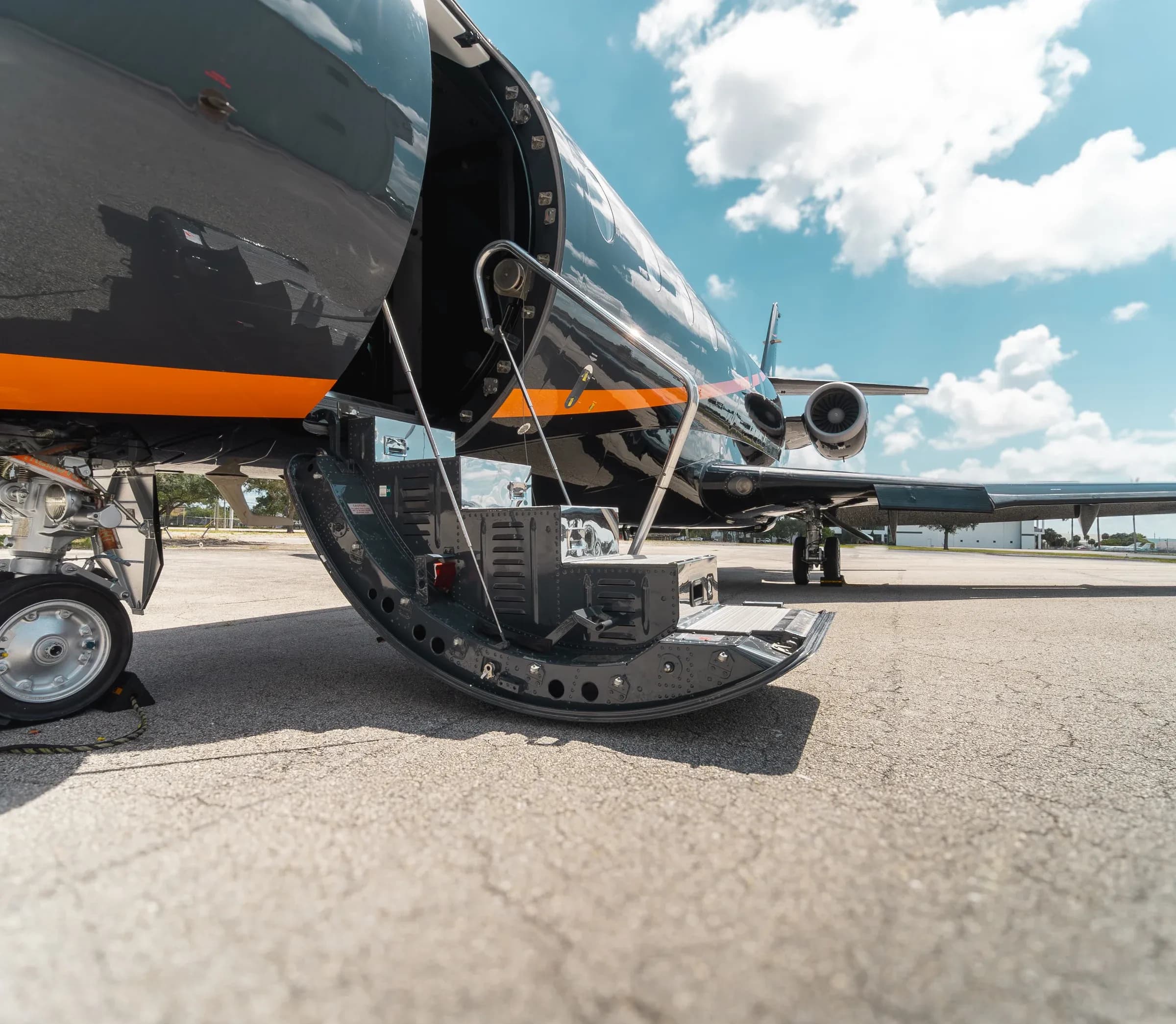 Low view of the Gulfstream G200 open entry stairs and front fuselage.