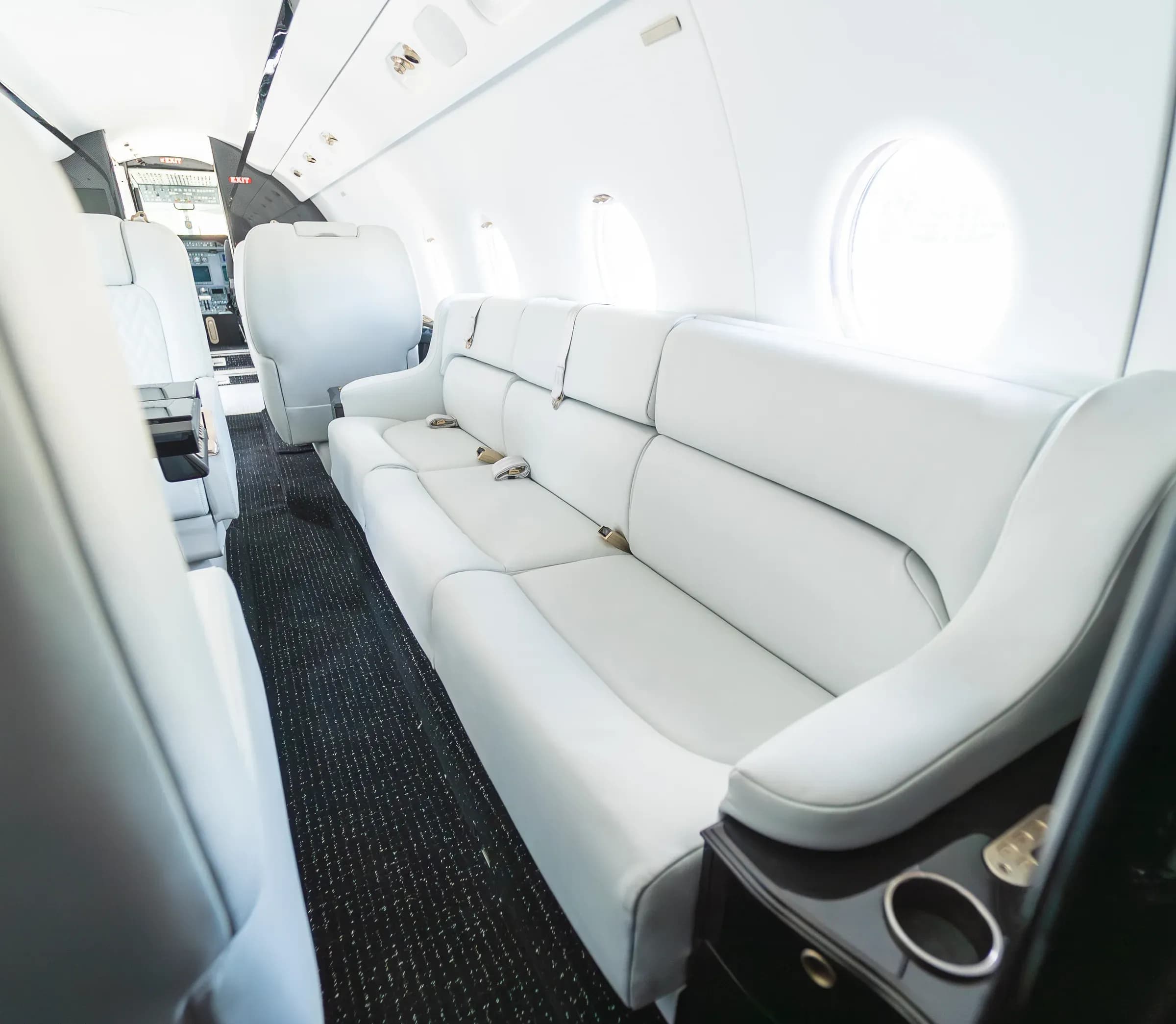 View along the white Gulfstream G200 divan toward the forward seating area.