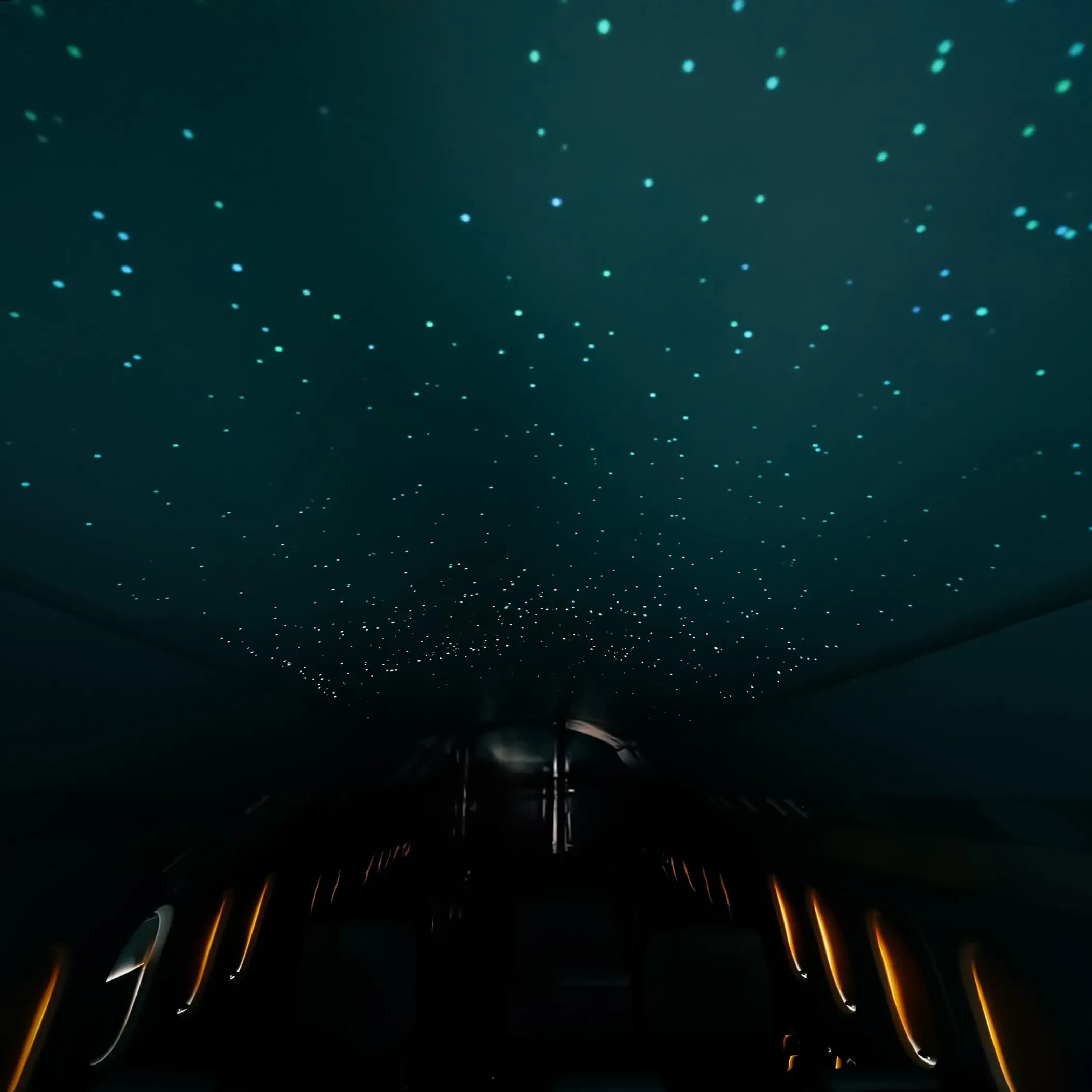 Falcon 2000 overhead panel lit with blue and warm points above the dark cabin.
