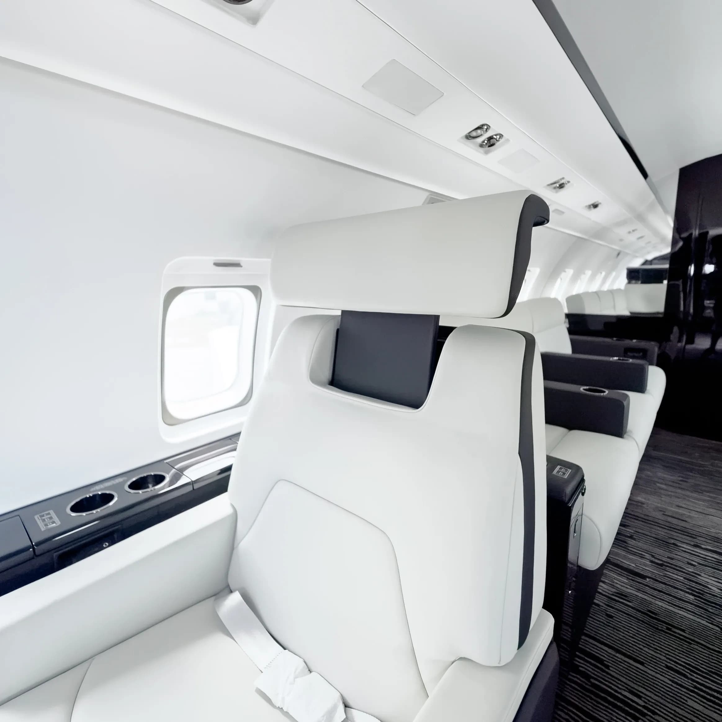 Challenger 604 seat back with tailored panel seams and a contrasting dark headrest insert.