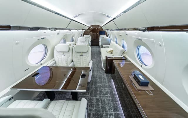 Elevated rear-corner view of the Gulfstream G650ER table and seating area.