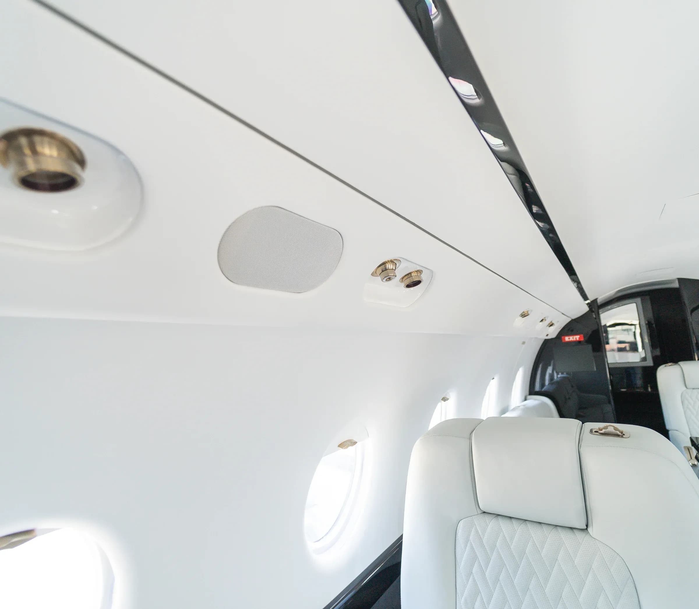 Overhead controls, speaker and lighting above the Gulfstream G200 seats.
