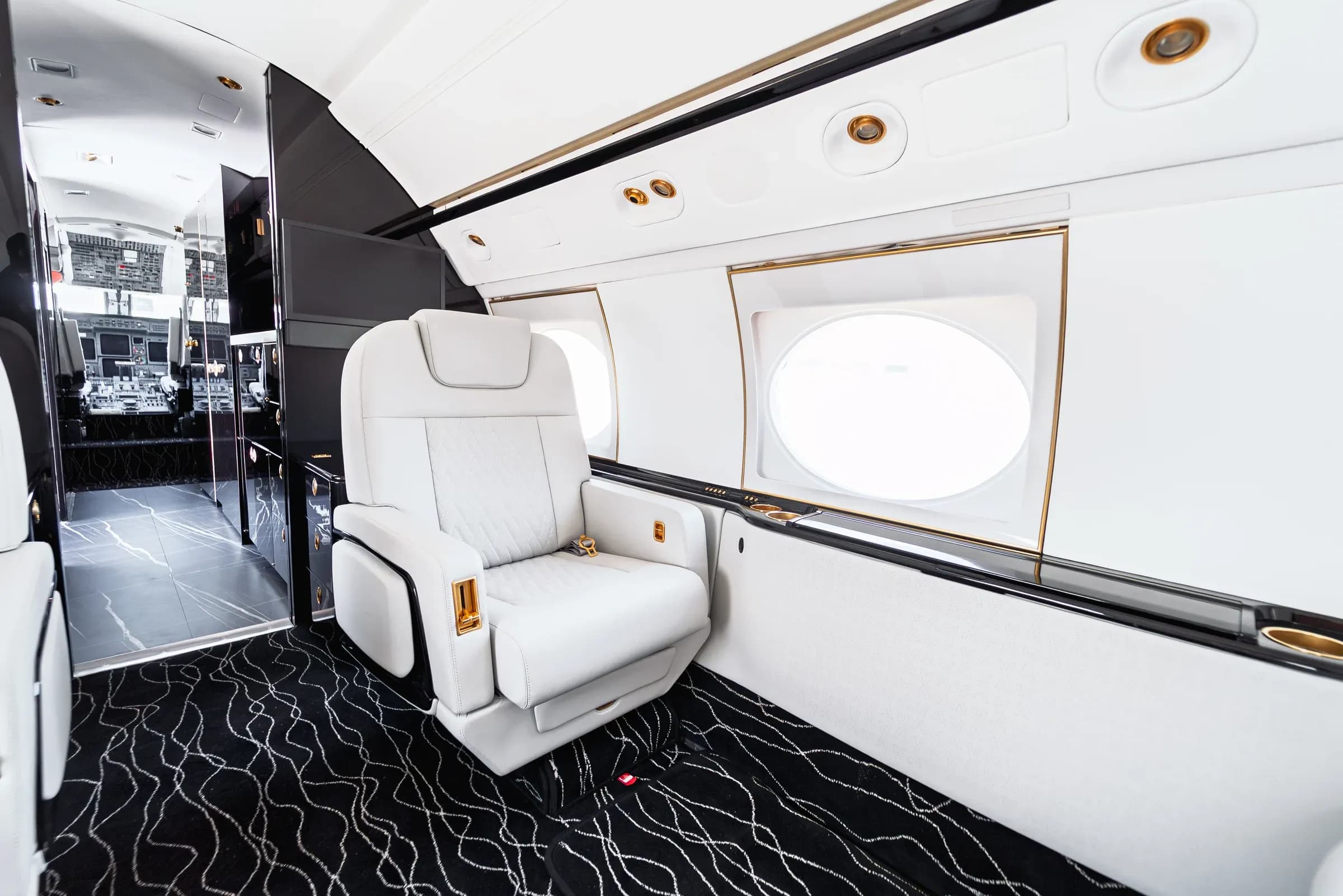 Gulfstream G550 forward seat beside the exit bulkhead and cockpit entrance.