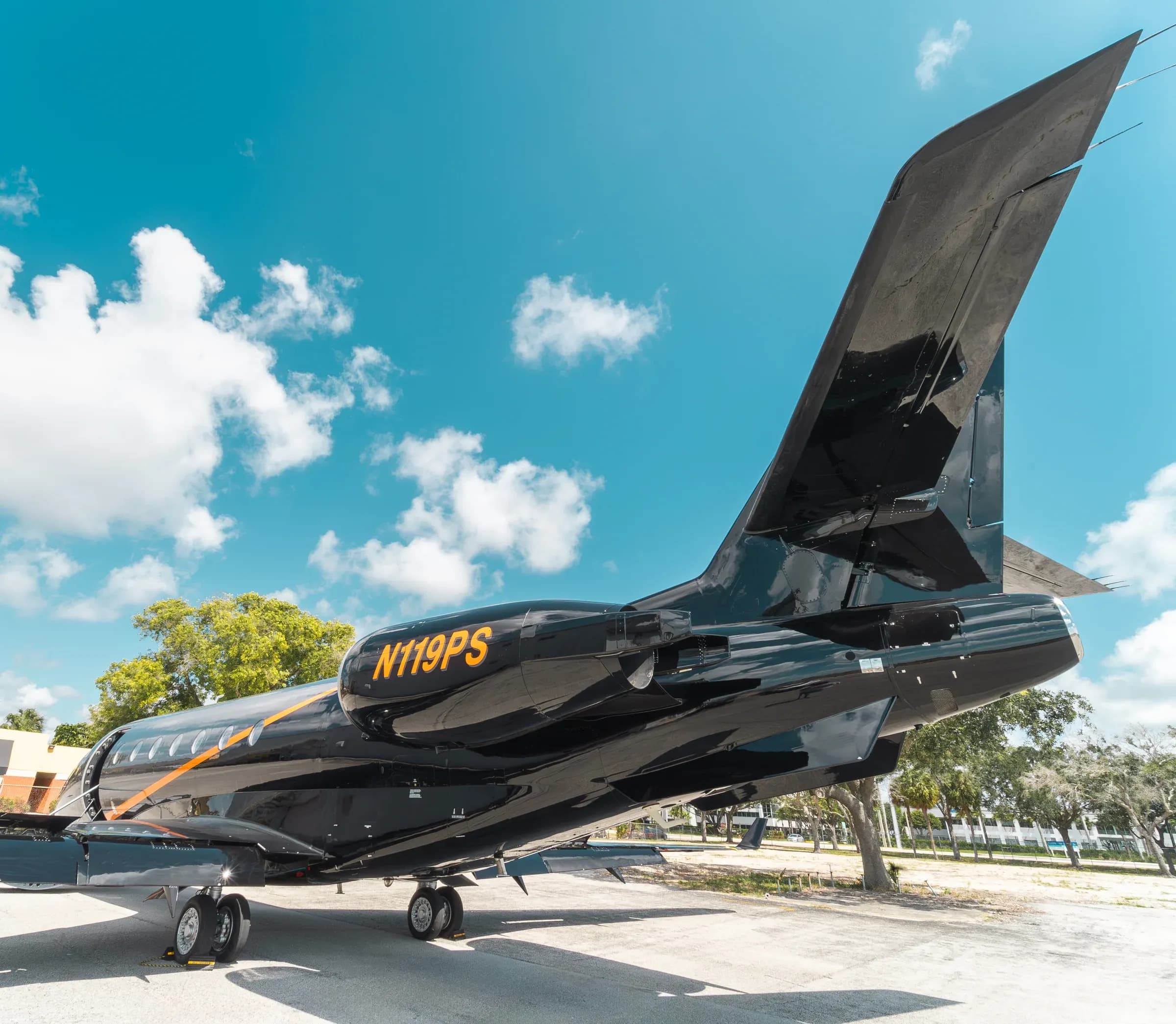 Close view of the Gulfstream G200 engine and tail with N119PS registration.