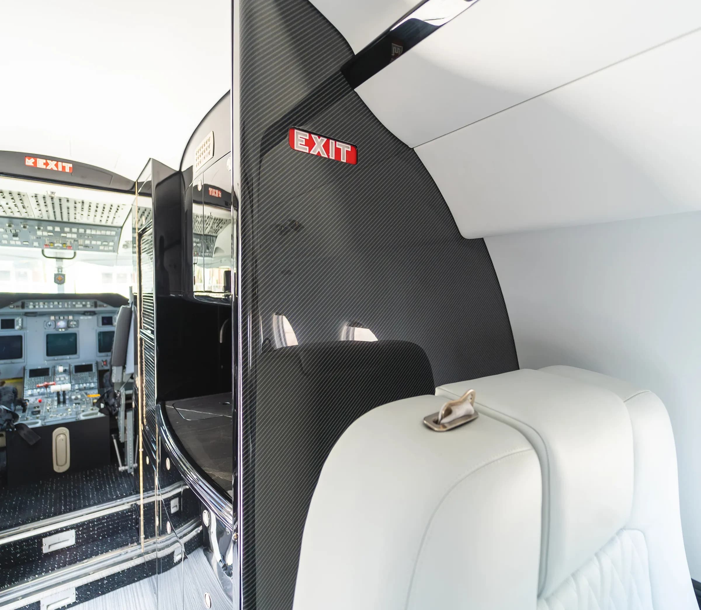 Dark forward cabinetry beside the Gulfstream G200 cockpit entrance.