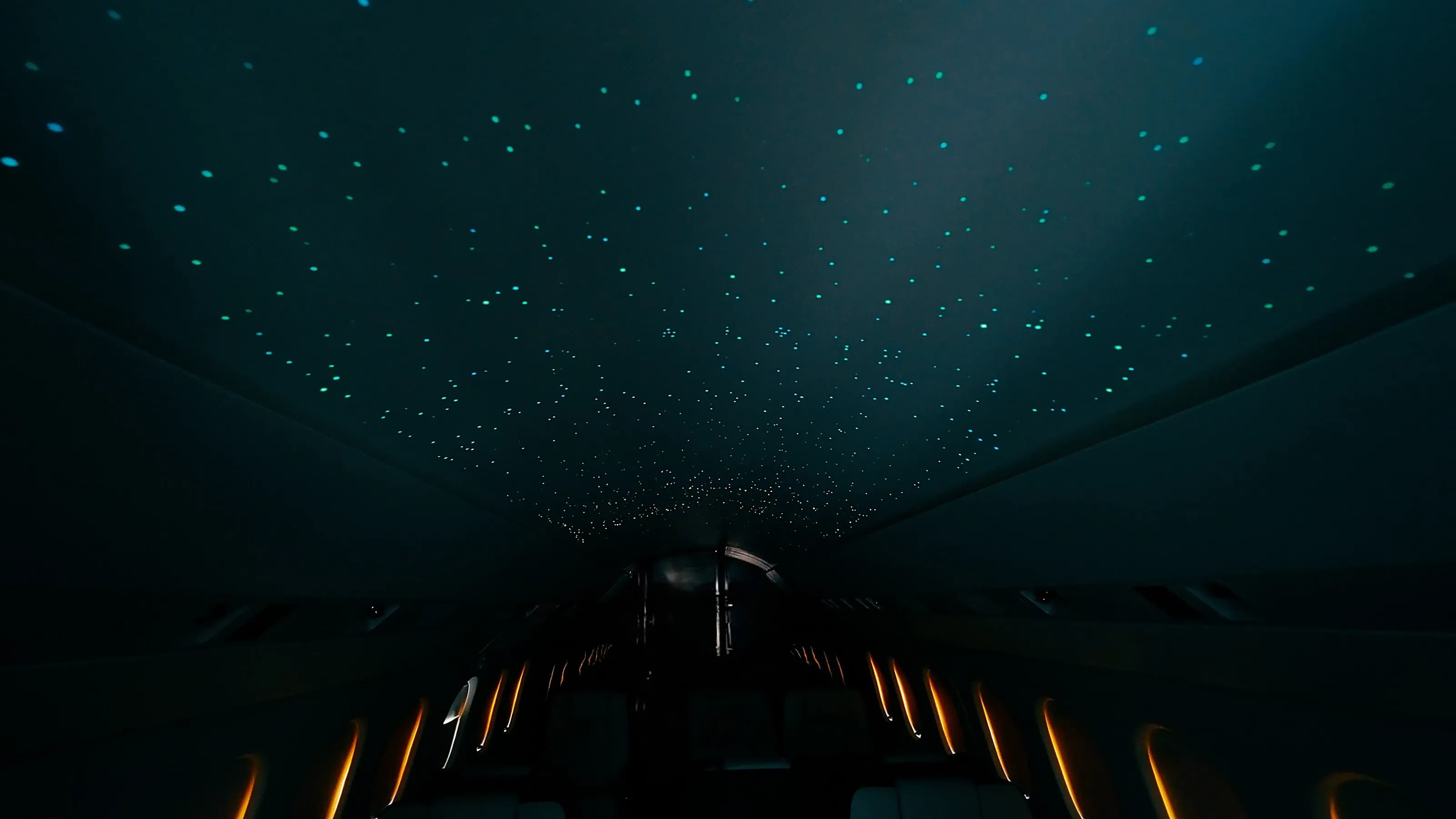 Falcon 2000 ceiling with scattered blue and warm points of light in a darkened cabin.
