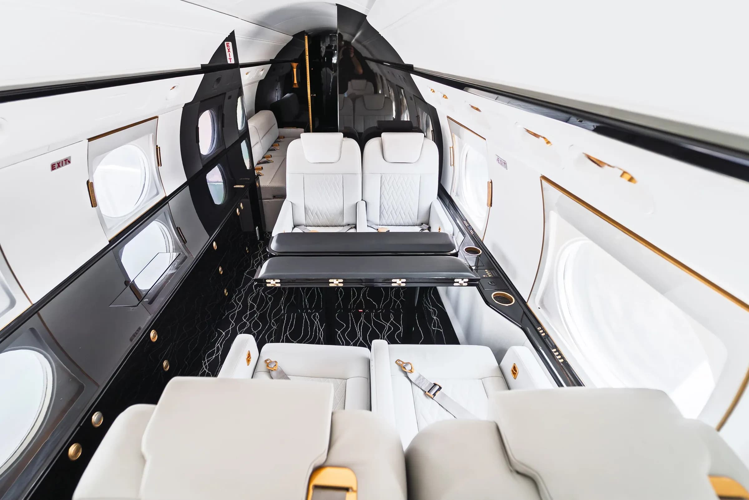 Elevated view of the Gulfstream G550 club seating and dark table.