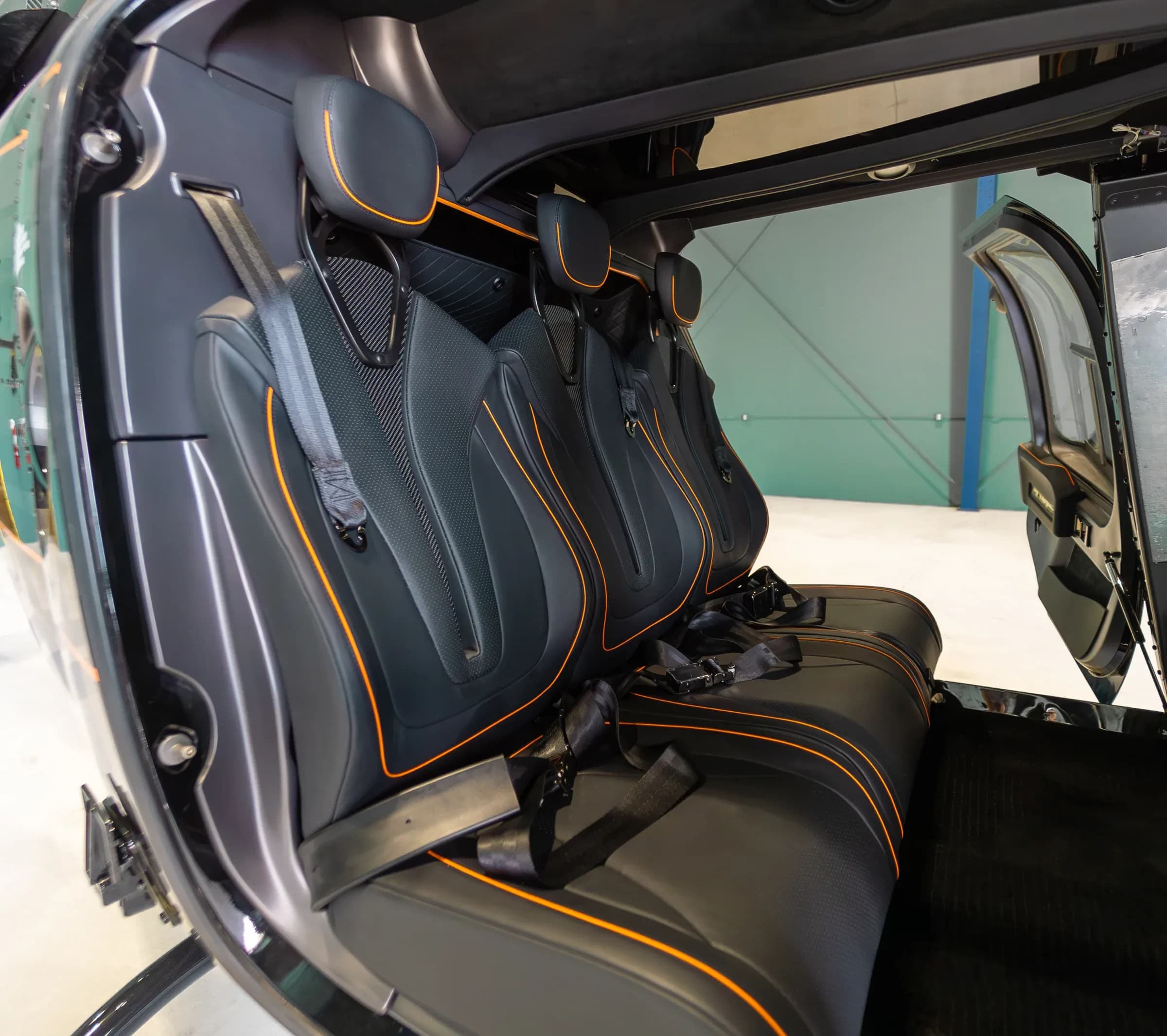 Bell 407 passenger seating viewed through the open cabin door.