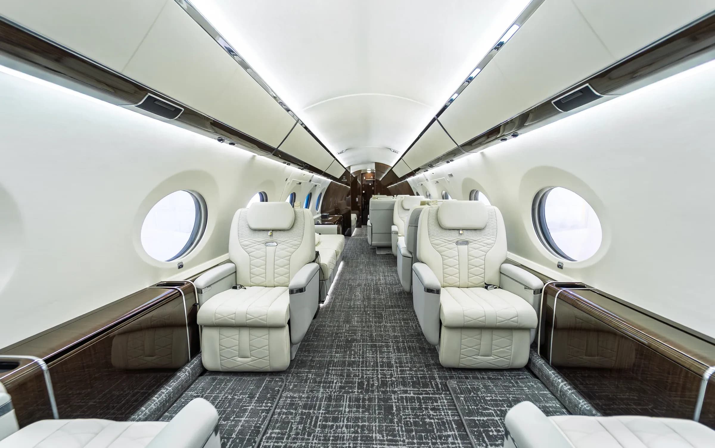 Elevated centered view through the Gulfstream G650ER cabin toward facing seats.