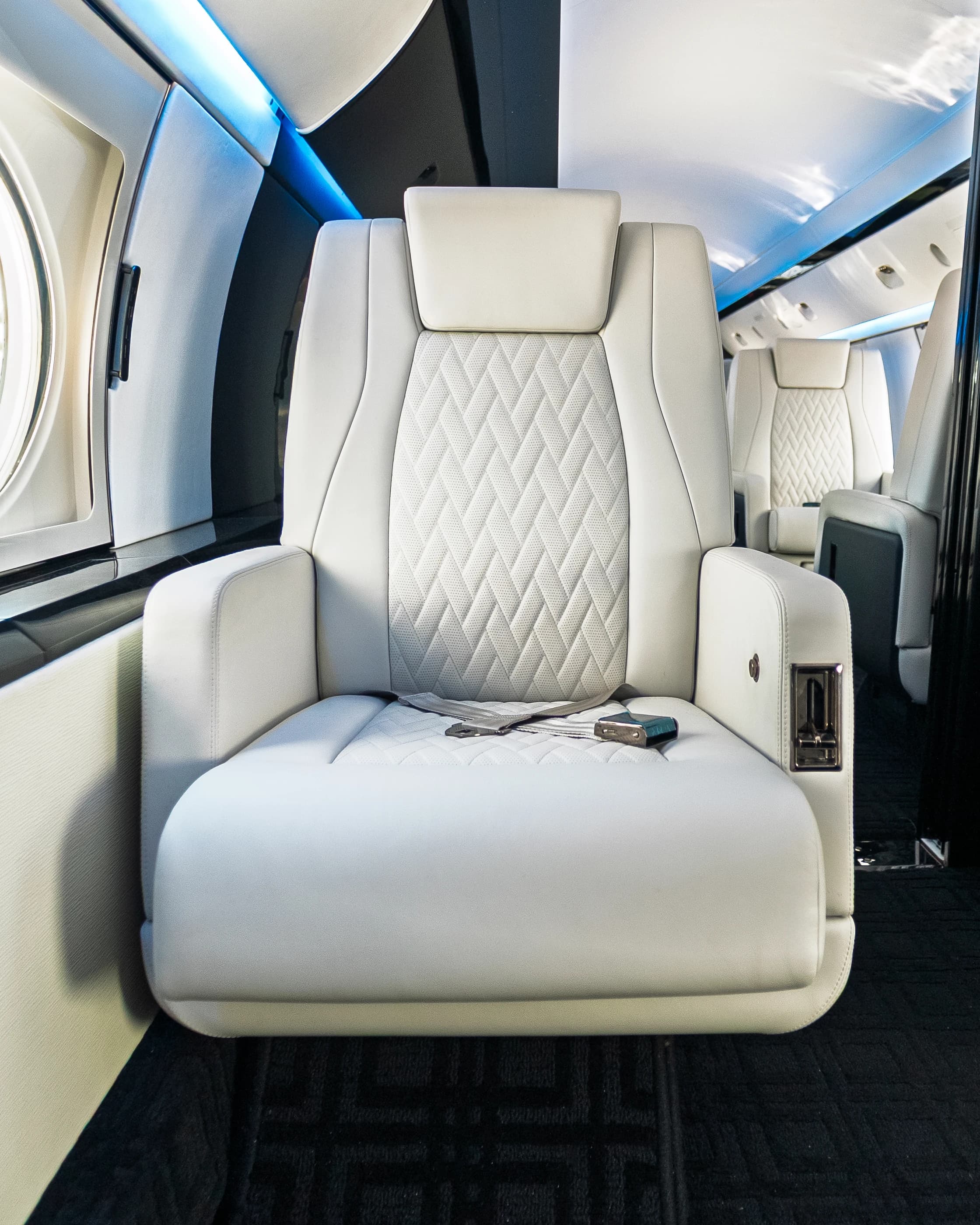 Frontal Gulfstream GIV ivory seat with its original diamond-stitched insert and dark cabin trim.