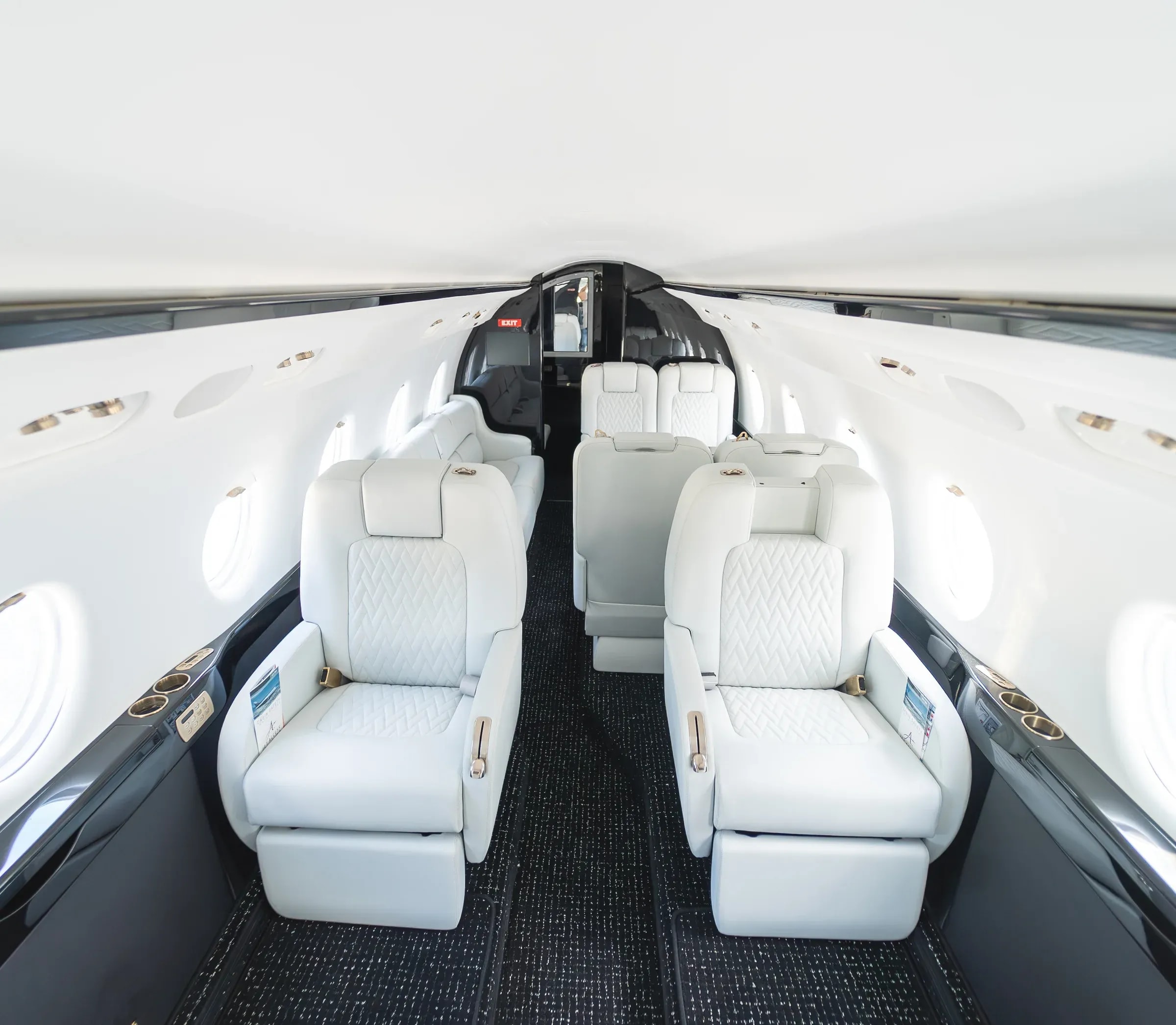 Elevated view of white Gulfstream G200 seating along the centered cabin aisle.