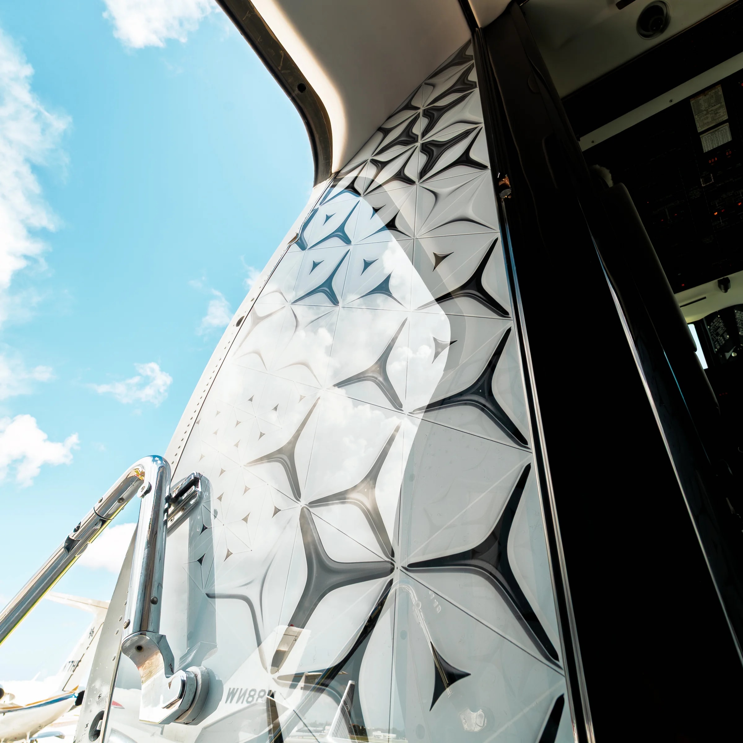 Close view of the sculpted geometric panel at the Gulfstream G-IV entrance.